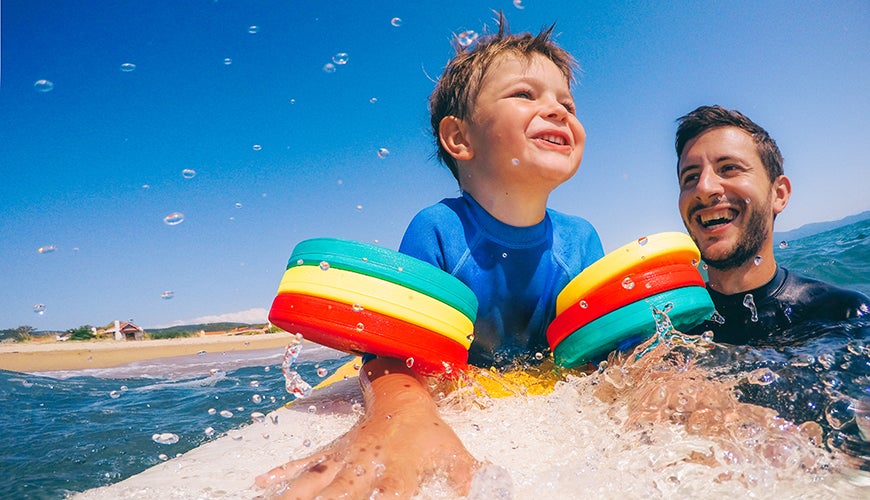 child taking part in surf lesson 