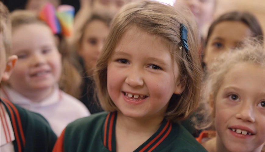 Schoolchildren smiling from the Child Safe Organisations video